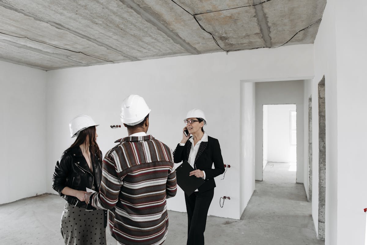 Contractor discussing loft conversion plans with clients on site